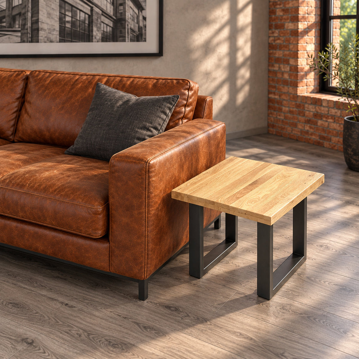Elevated view of the Fusion oak lamp table's square tabletop and two separate metal loop bases next to a cognac sofa.