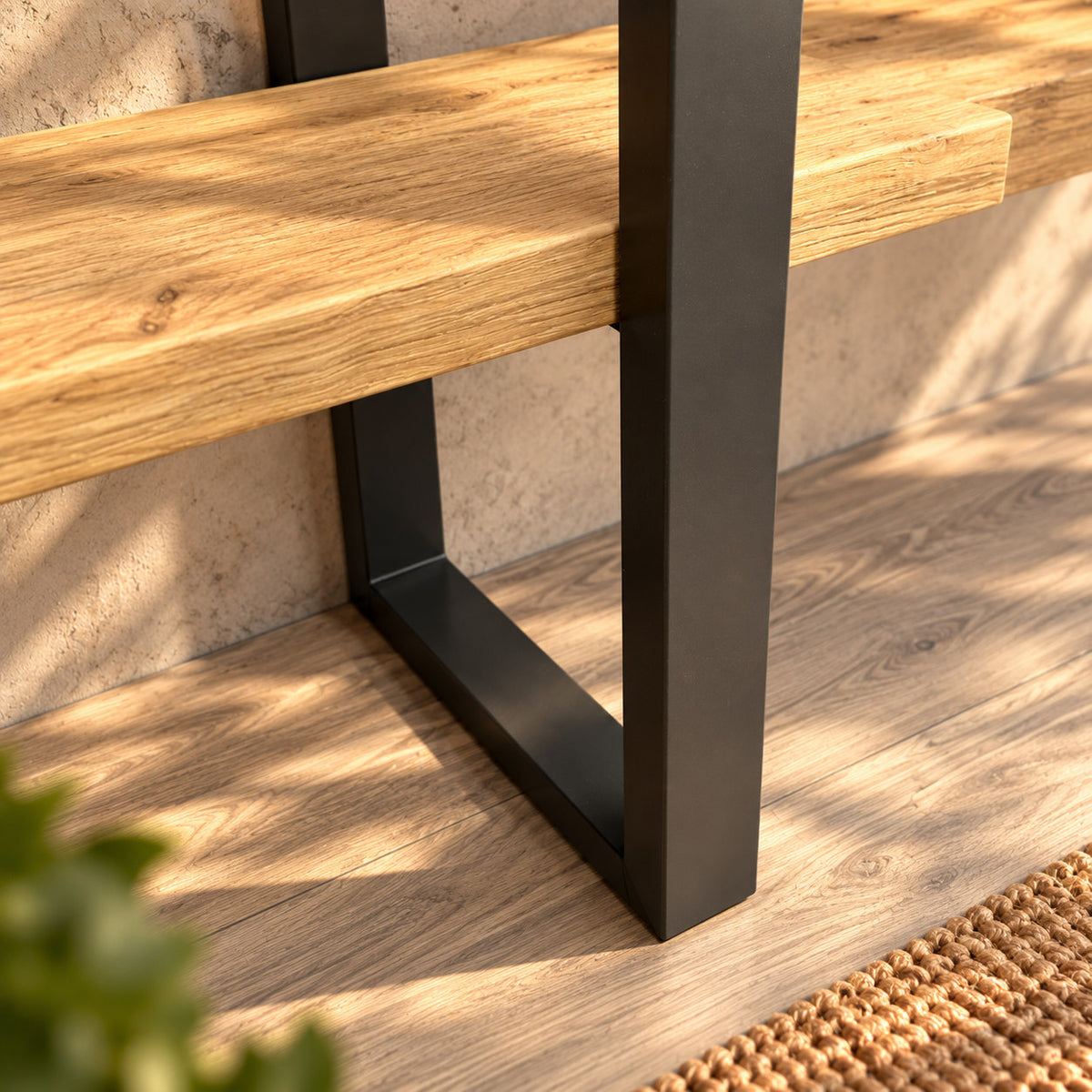 Close-up of the Fusion shelf unit's rectangular metal base and lower oak shelf.