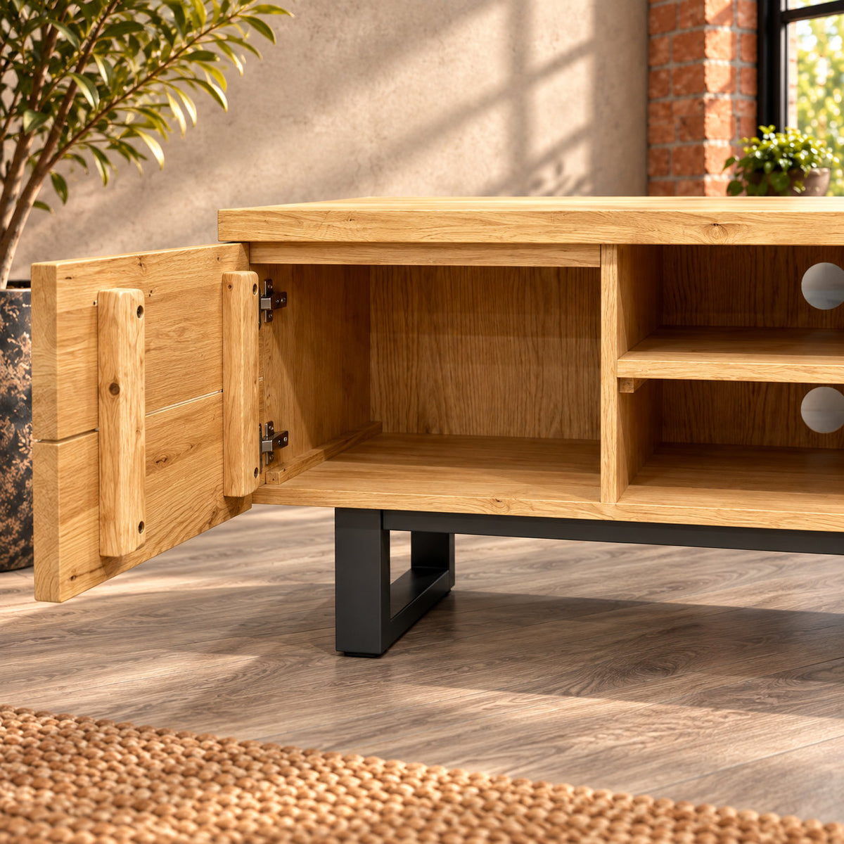 Close-up of an open Fusion oak TV unit cupboard, showing the unshelved interior and timber bracing inside the door.