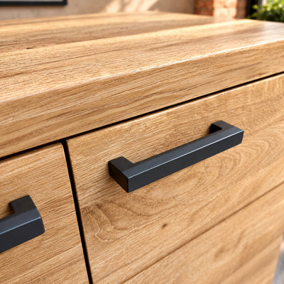 Close-up of the thick oak top edge and paired dark metal handles on the Fusion Oak FS2SB sideboard.