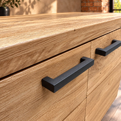 Close-up of the thick oak top edge and paired dark metal handles on the Fusion Oak FS2SB sideboard.