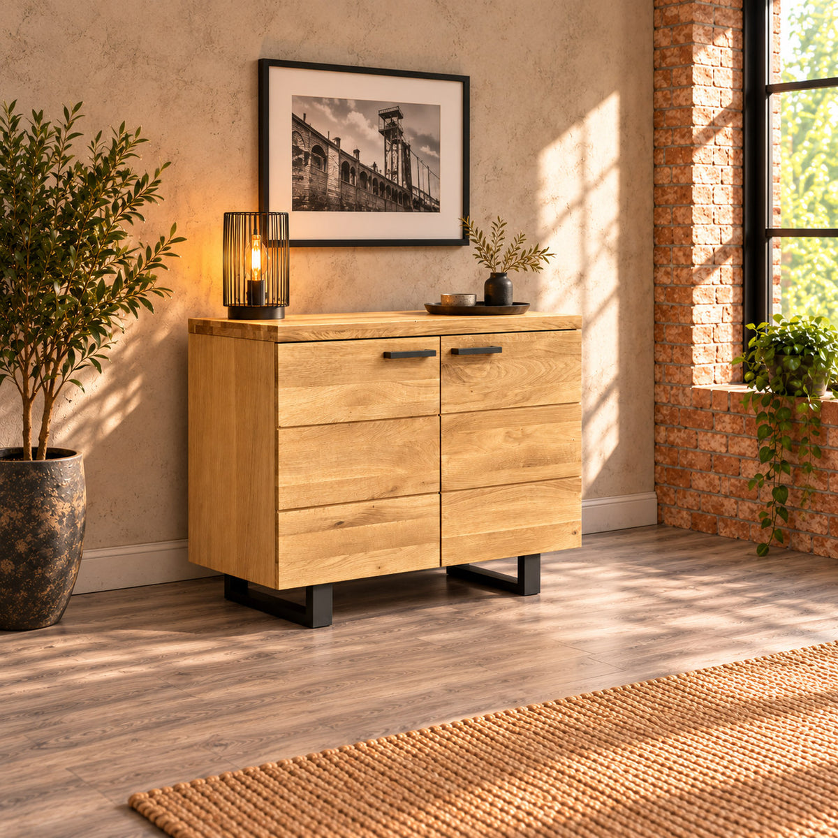 Fusion Oak FS2SB sideboard against a plaster wall in an industrial-style room with a black metal lamp, brickwork and an olive tree.