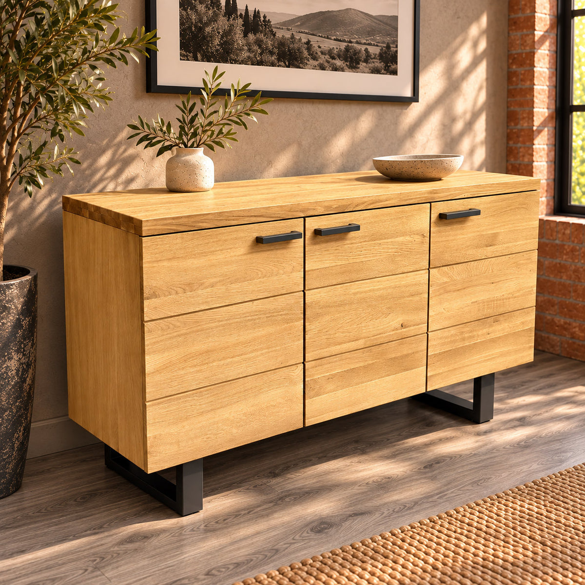 Angled view of the Fusion oak sideboard showing the textured oak top, three doors and black metal base.
