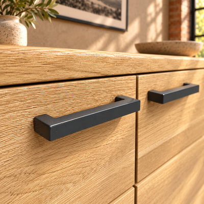 Close-up of the Fusion sideboard's charcoal rectangular bar handles against the textured oak doors.