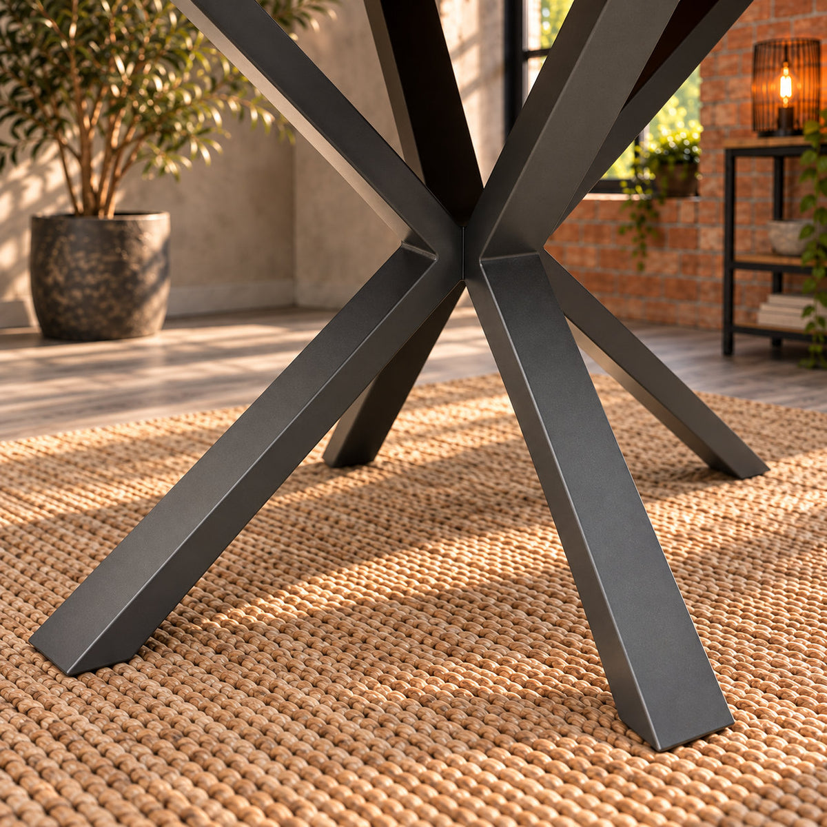 Close-up of the angular central junction and charcoal finish on the Fusion compact dining table’s metal pedestal.