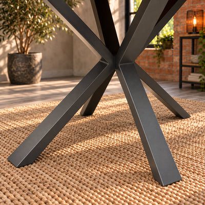 Close-up of the angular central junction and charcoal finish on the Fusion compact dining table’s metal pedestal.