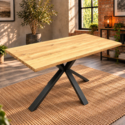 Fusion oak compact dining table with an unstyled sandblasted oak top and central metal pedestal in a sunlit room.