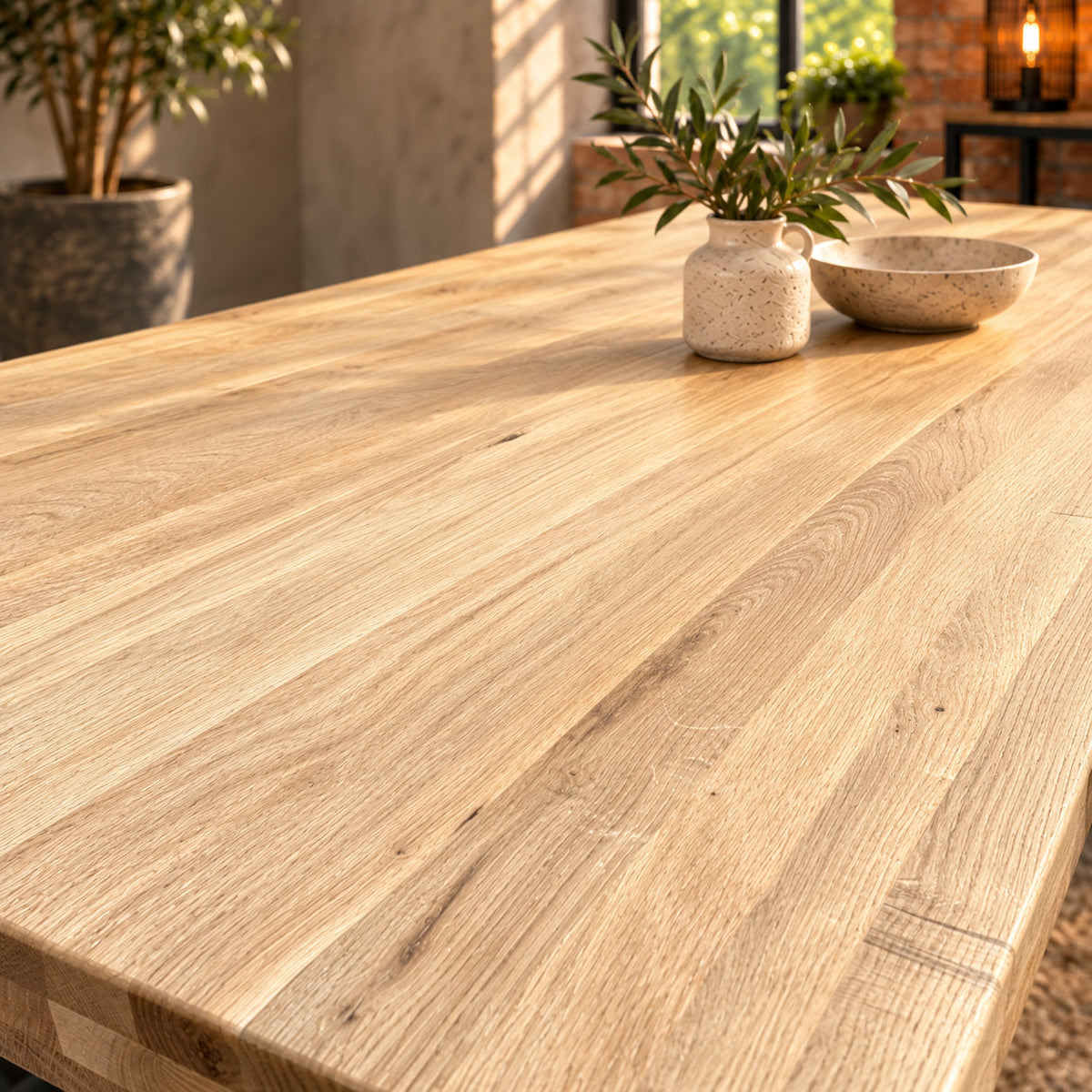 Close-up of the Fusion large dining table’s sandblasted oak surface, showing subtle raised grain and natural texture.
