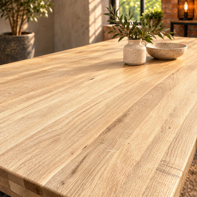 Close-up of the Fusion large dining table’s sandblasted oak surface, showing subtle raised grain and natural texture.