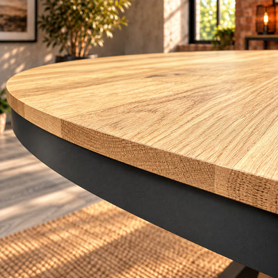 Close-up of the Fusion round table's slim curved oak edge above its charcoal metal rim.

