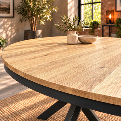 Oblique view across the Fusion round table's textured oak top, with a ceramic vase and bowl.
