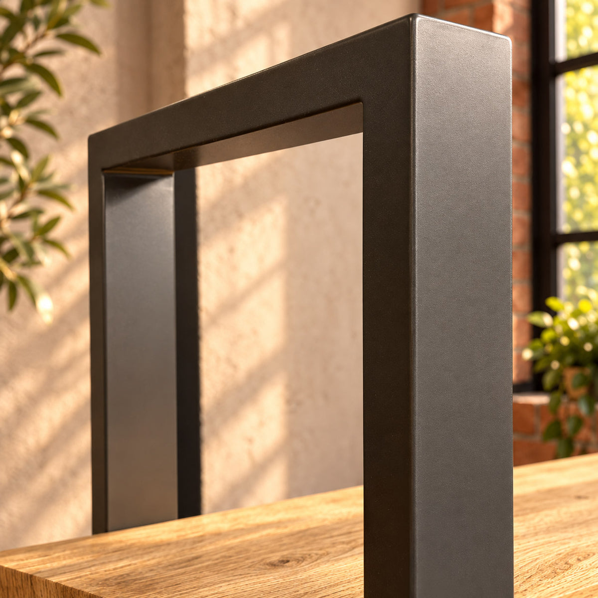 Detail of the Fusion shelf unit's charcoal rectangular metal frame above the top shelf.
