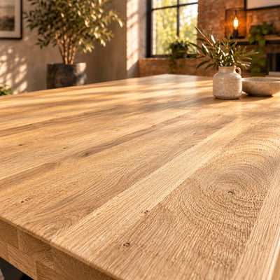 Side-lit detail of the Fusion oak dining tabletop highlighting the subtle texture of its sandblasted grain.