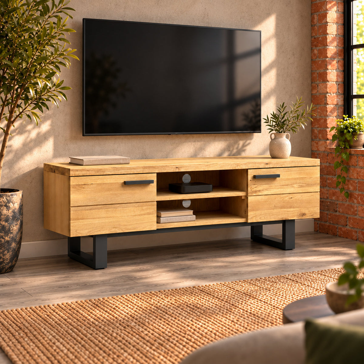 Fusion oak TV unit beneath a wall-mounted television, with books in the lower central compartment and a small media box above.
